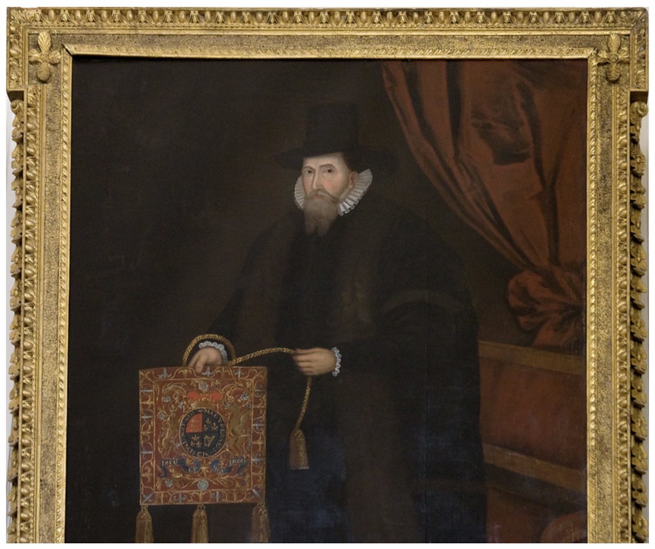 Archbishop-Chancellor Adam Loftus (1533-1605). The portrait is in Trinity College Dublin, as he was the first Provost. He was also Keeper of the Great Seal of Ireland, and he is here holding the embroidered purse which held the seal. Image: Irish Historic Houses