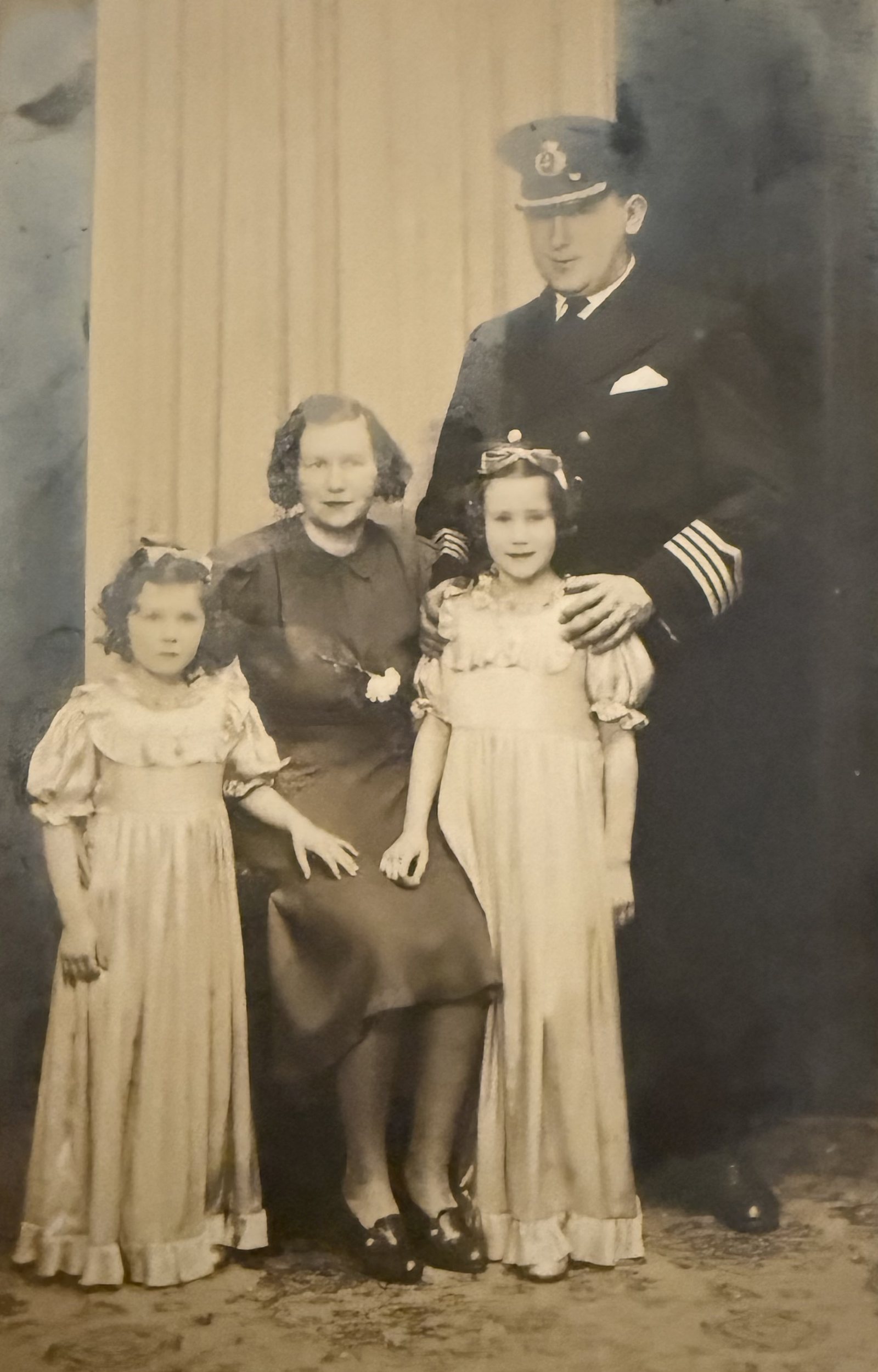Captain Harry Jones in his Merchant Navy master's uniform, with his family. From the family album.